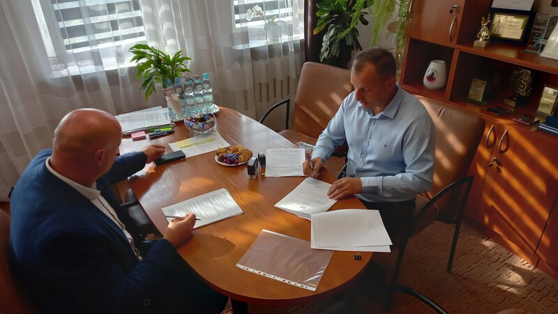 Podpisanie umowy w Urzędzie Gminy Raków, po lewej stronie Wójt Gminy Raków, po prawej wykonawca